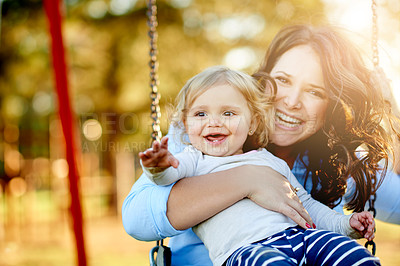 Buy stock photo Park, laugh and mom with child on swing for fun, bokeh and playing together on weekend morning. Family, portrait and mother with girl on playground for bonding, relationship and happy outdoor