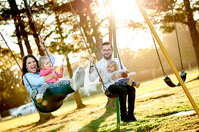 Buy stock photo Nature, swings and parents with kids in park for holiday, weekend or vacation together. Smile, trees and children with mother and father for playing outdoor on playground for connection in summer.