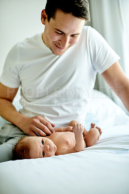 Buy stock photo Dad, baby and happy on bed in home for love, touch or bonding with play in morning. People, father and newborn with smile, connection and affection with infant child in nursery at family house