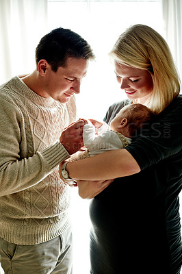 Buy stock photo Happy, morning and parents with baby in home for bonding, relationship and love for affection. Family, parenting and embrace with dad, mom and newborn for comforting, trust and security together