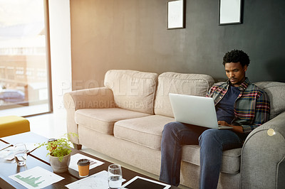 Buy stock photo Black man, laptop and typing on sofa, office or notification for project funding at interior design company. Person, computer and creative process for renovation job at property development agency