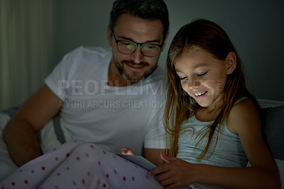Buy stock photo Night, father and daughter in bedroom with tablet for digital story app, audiobook or playing games. Late, parent and child in home with tech for reading ebook, watching video or bonding together.