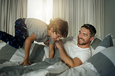 Buy stock photo Smile, playful and father with son in bedroom of house for wake up, bonding and morning game. Support, happiness and relax with man and child in bed of family home for love, care and energy together