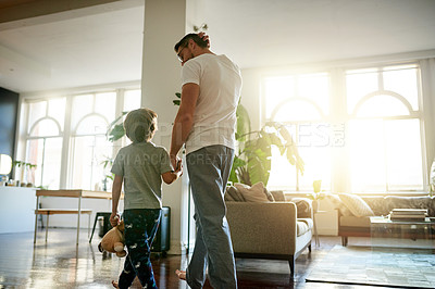 Buy stock photo Back, father or son walking in living room with hand holding for morning bonding, conversation or waking up. Love, caring man or child in home for trust development, flare or support in communication