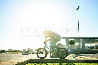 Buy stock photo BMX, man and bicycle in city for exercise, eco friendly travel and cycling with space. Person, riding bike and cyclist on curb outdoor for fitness, urban sports and balance for cardio with flare