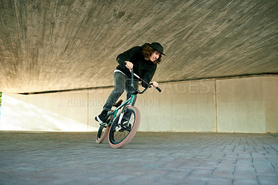 Buy stock photo BMX, exercise and ride with man on bike for activity, adrenaline hobby or extreme sports training. Fitness, risk and speed with person on bicycle underground for action, energy or urban cycling