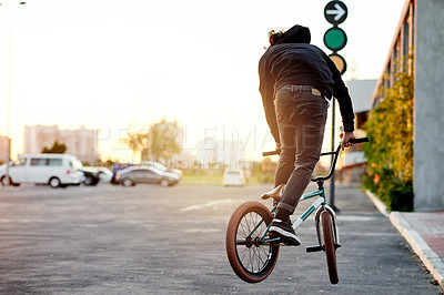 Buy stock photo City, back and man on bicycle for cycling, training skill or tricks in urban town to practice. Cool trick, athlete or stunt biker in parking lot for exercise, fitness or outdoor sports for biking