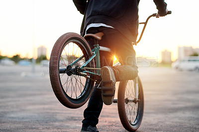 Buy stock photo Back view, city and person on bicycle for trick, flip with stunt or skill outdoor for extreme sports. Cyclist, rider and bike for challenge, performance or action in urban park at sunset with talent