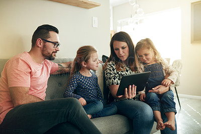 Buy stock photo Parents, children and relax on couch with tablet, bonding and choice for film in family home. People, mother and father with girl kids, tech and app for subscription, movie or streaming show at house
