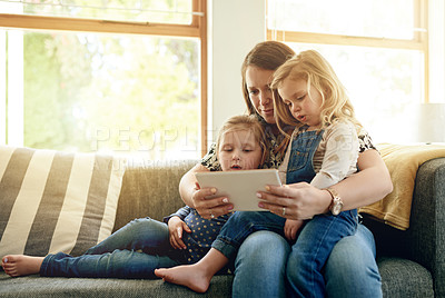 Buy stock photo Mother, girls and tablet on sofa with smile, love and together for video, cartoons and relax in home. Woman, children and digital tech for social media, games or movies in living room in family house
