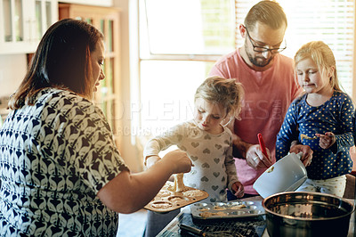 Buy stock photo Baking, help and muffins with family in kitchen for support, cooking and learning dessert recipe. Teaching, bonding and food with parents and children in home for cupcake, love and growth together