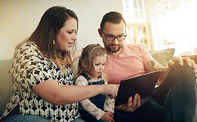 Buy stock photo Tablet, relax and parents with child on sofa for watching movie, series or show online together. Happy, digital technology and girl toddler with mother and father for streaming film on app in home.