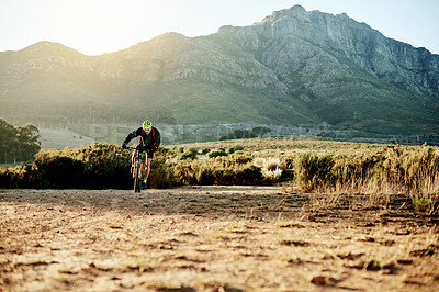 Buy stock photo Mountain bike, off road and speed with man outdoor for exercise, fitness or sports hobby. Scenic, trail and view with person cycling in nature for cardio challenge, performance or training on space