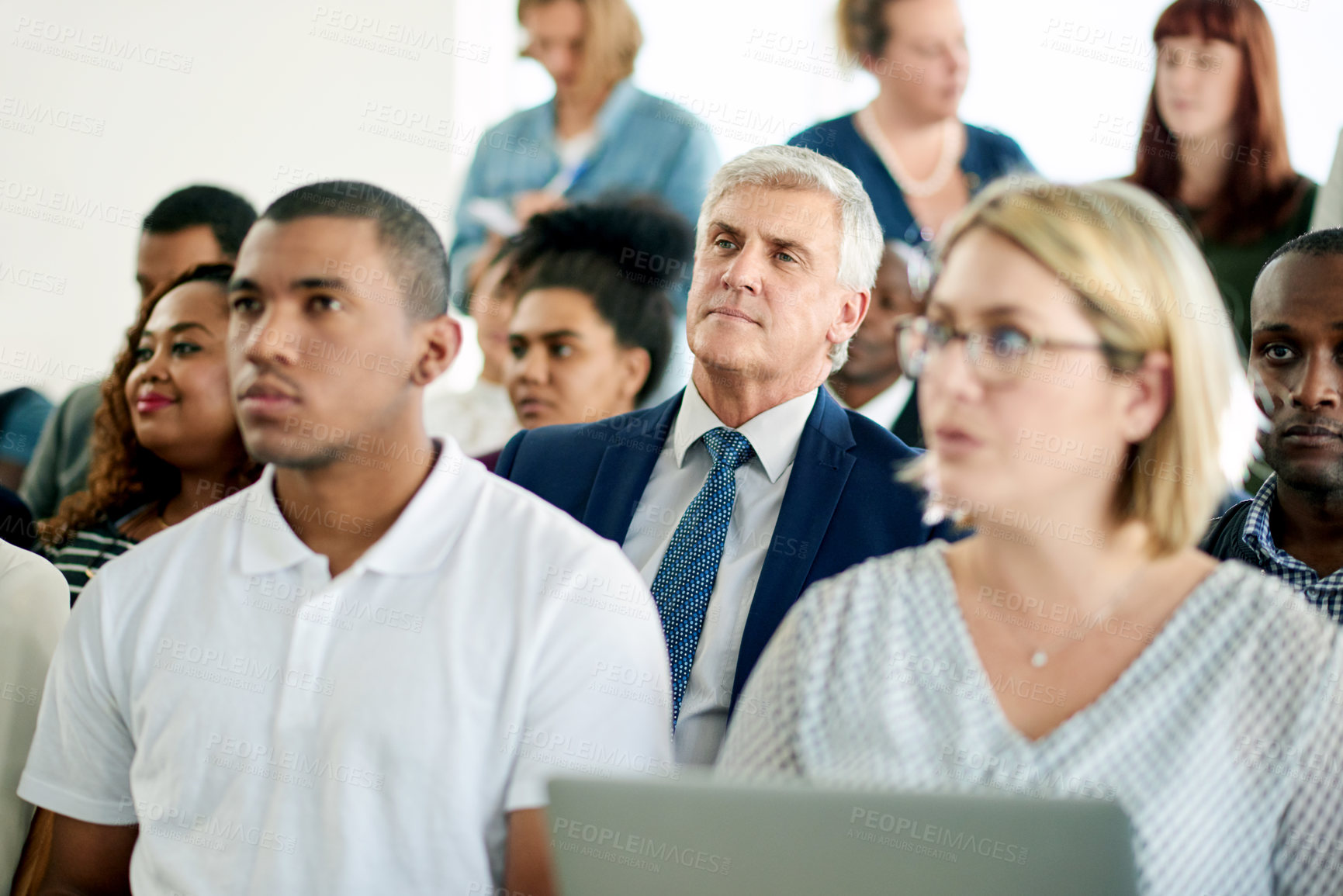 Buy stock photo Mature man, audience and listen at conference with attention, info and presentation at company event. Business people, crowd and employees with perspective, seminar and corporate convention at agency