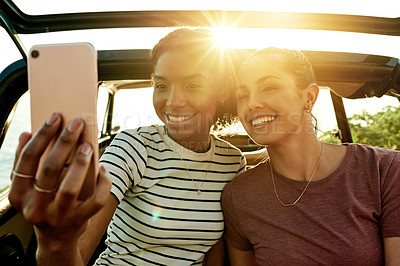 Buy stock photo Selfie, smile and car with friends in nature together for holiday, travel or vacation. Photograph, road trip and social media with happy women outdoor for profile picture with flare and destination