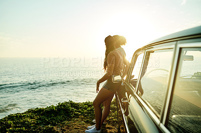 Buy stock photo Shot of two young women enjoying a road trip
