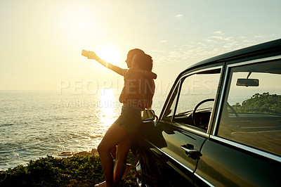 Buy stock photo Shot of two young women taking selfies with a mobile phone on a road trip