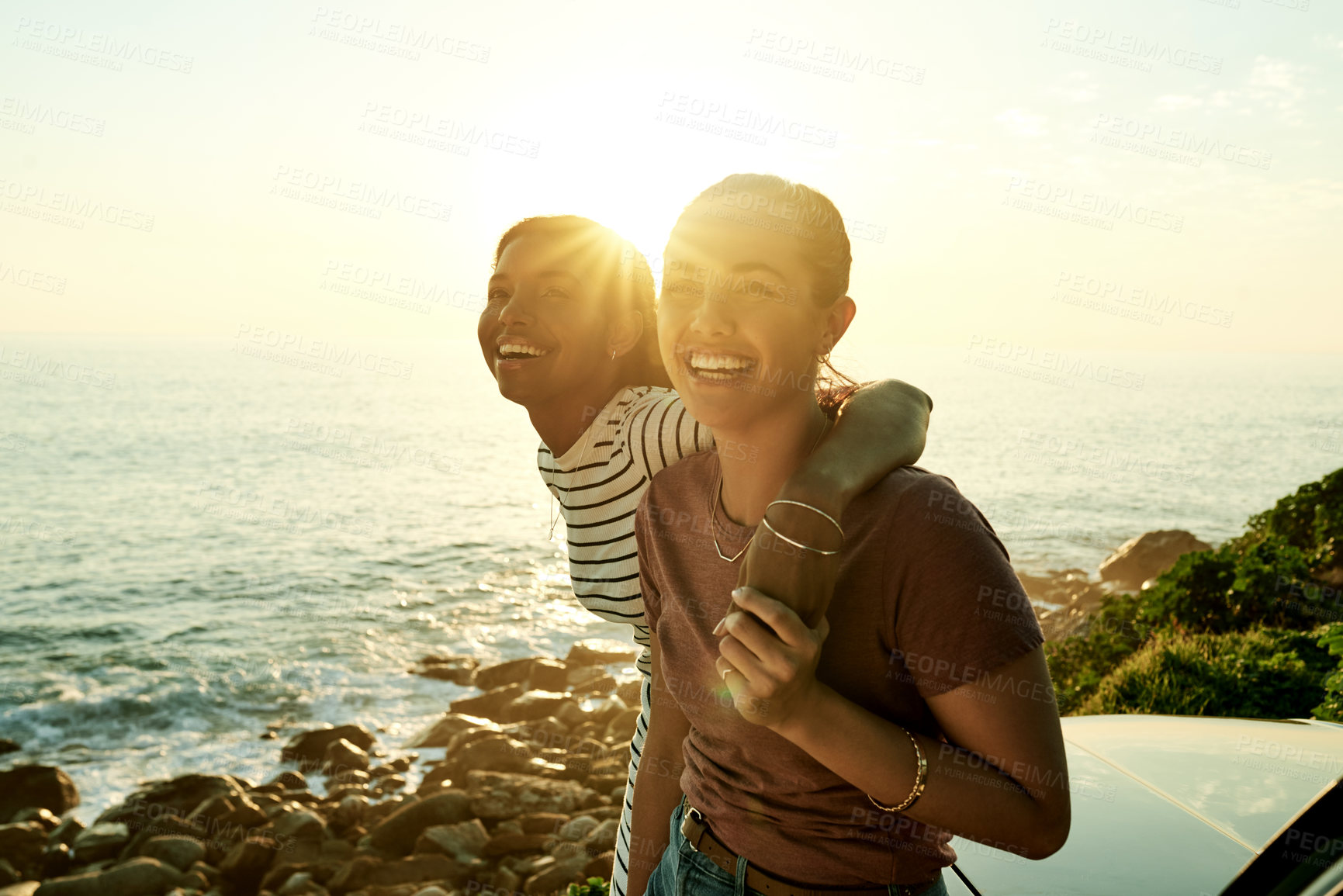 Buy stock photo Portrait, hug and women with car, sea and bonding on road trip, getaway or summer vacation or flare. Tourist, friends and embrace on holiday with vehicle, transport and laugh on weekend or ocean