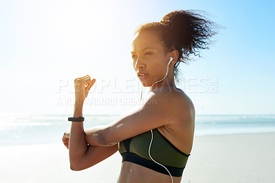 Buy stock photo Earphones, stretching and thinking with woman on beach for start of cardio training or workout. Arms, fitness and music with African athlete outdoor on space for exercise preparation or warm up