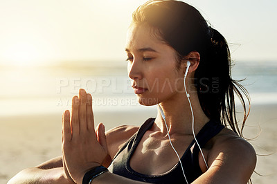 Buy stock photo Beach, meditation and woman with earphones, hands and listening to chanting for peace, zen or outdoor. Namaste, mindfulness and streaming mantras on radio, calm or self awareness for music in nature