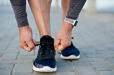 Buy stock photo Man, fitness and tie shoelace by beach, sports preparation and outdoor for marathon training. Male person, sneakers and getting ready for cardio challenge on sea promenade, runner and start workout