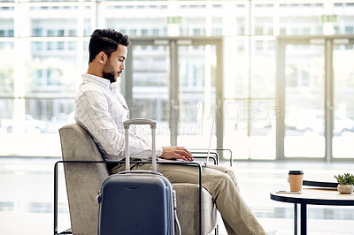 Buy stock photo Laptop, reading and business man in airport lobby for conference, travel and email confirmation. Online booking, seminar schedule and flight with person, luggage and tech for reservation information