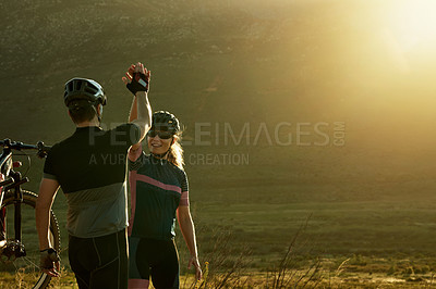 Buy stock photo Cycling, high five and couple with bicycle in nature for fitness goals on adventure, exercise and race. Lens flare, space and man with woman celebrate on mountain for training, challenge and support