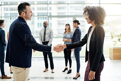 Buy stock photo Lobby, meeting and business people with handshake in office for greeting, collaboration and networking. Corporate, happy and man and woman shaking hands for agreement, B2B partnership and welcome
