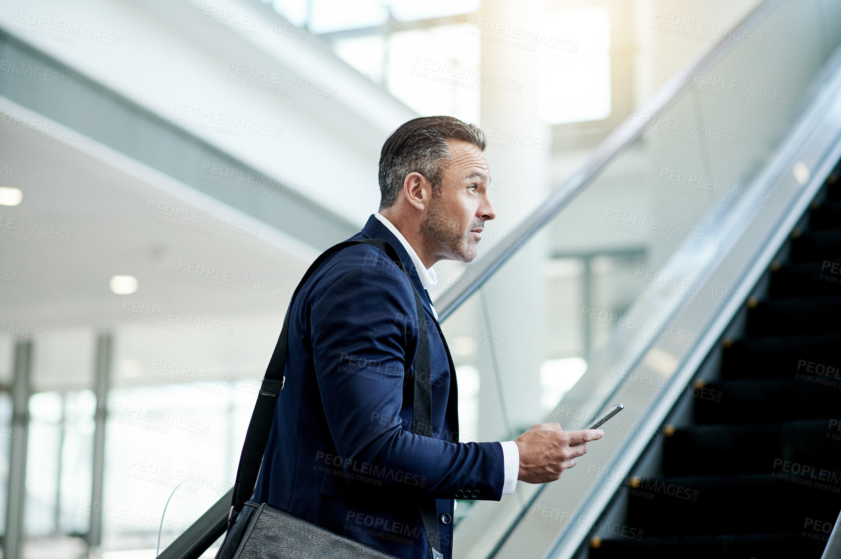 Buy stock photo Escalator, airport or businessman with phone for thinking, commute or arrival in lobby. Conference, professional or mature person on electric stairs on mobile for flight schedule, trip or travel info