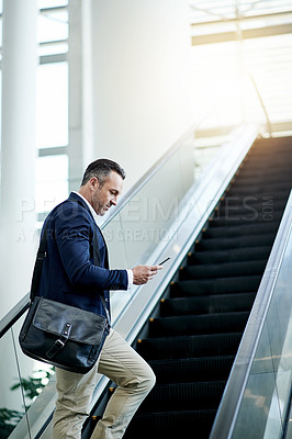 Buy stock photo Escalator, airport and businessman with phone for appointment, commute and arrival in lobby. Mature CEO, professional and person on electric stairs on mobile app for flight schedule, trip or travel