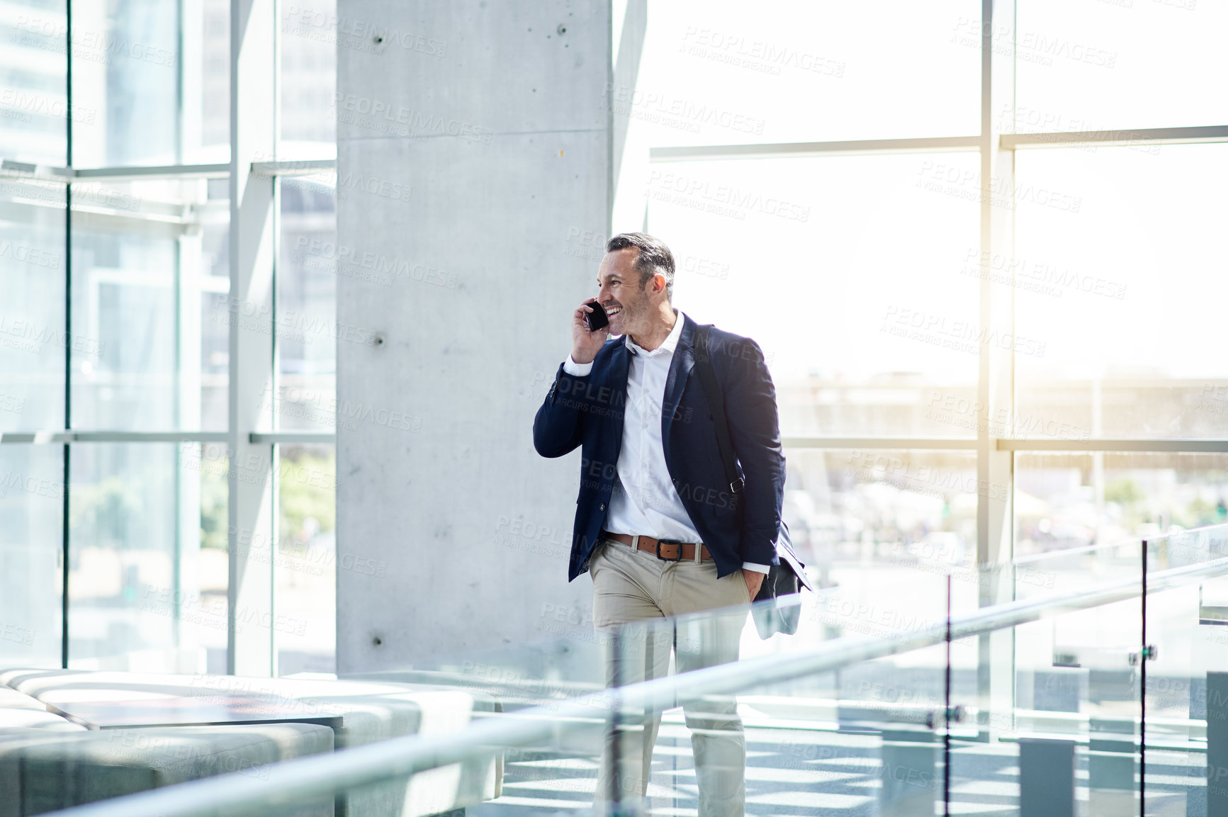 Buy stock photo Phone call, thinking and walking with business man in foyer for feedback, negotiation or update. Communication, conversation and smile with mature employee in lobby of office for project management