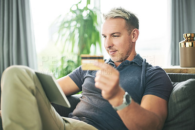 Buy stock photo Credit card, tablet and man with online shopping on sofa for ecommerce, payment or sale. Customer, website and person with banking app in home living room for transaction, subscription or order