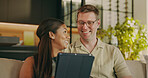 Relax, love and tablet with interracial couple on sofa for streaming service, bonding and smile. Film subscription, connection and happy with man and woman in living room in home for media app