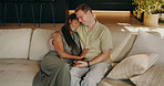 Couple, relax and holding hands on couch with smile, love and romantic partner on valentines day. Happy, interracial people and unwind in home for romance, embrace spouse and affection for commitment