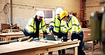 Woodworking, team and men with laptop in warehouse, discussion or planning for furniture production. Engineer, collaboration and people with tech, point and project management with intern in factory