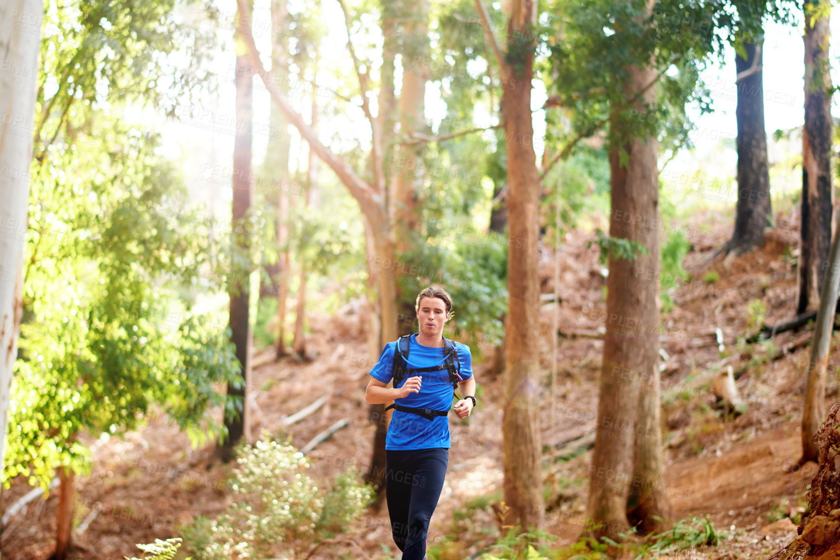 Buy stock photo Running, fitness and man in nature for workout, marathon training and cardio exercise. Sports, forest and athlete in woods for wellness, healthy body and endurance for race, challenge and competition