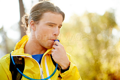 Buy stock photo Hydration pack, fitness and man in woods, runner and resting with wellness, thirsty and exercise. Healthy person, outdoor and athlete in forest, drinking water and mountain hiking with training