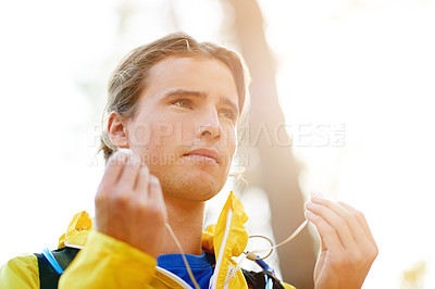 Buy stock photo Man, fitness and listening with earphones for music, podcast or audio in nature or forest. Male person, active or runner with sound playlist for sport, low angle or outdoor workout in woods or park