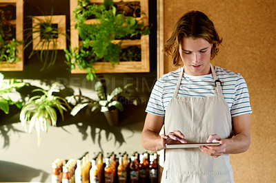 Buy stock photo Cafe, barista and man on tablet for reviews, inventory and stock with seasoning options. Coffee shop, order and male waiter with touchscreen for managing sales, search and store service in restaurant