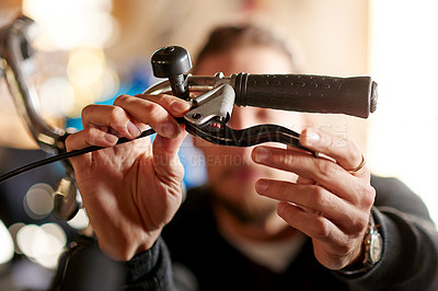 Buy stock photo Repair, hands and man with handle, bike store and maintenance with inspection. Closeup, person and employee with bicycle, fixing and check brakes with skills, small business and eco friendly