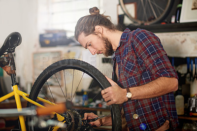 Buy stock photo Wheel, repair or man with bike in workshop or store for fixing, maintenance or upgrade. Small business, warehouse or male mechanic in garage for bicycle parts, mechanical engineering or tyre change