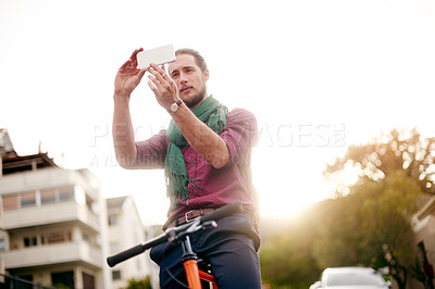 Buy stock photo Travel, picture or man on bicycle in city for holiday vacation, trip or sightseeing memory. Sunrise, explore or tourist in urban town with bike for outdoor adventure, social media post or tourism