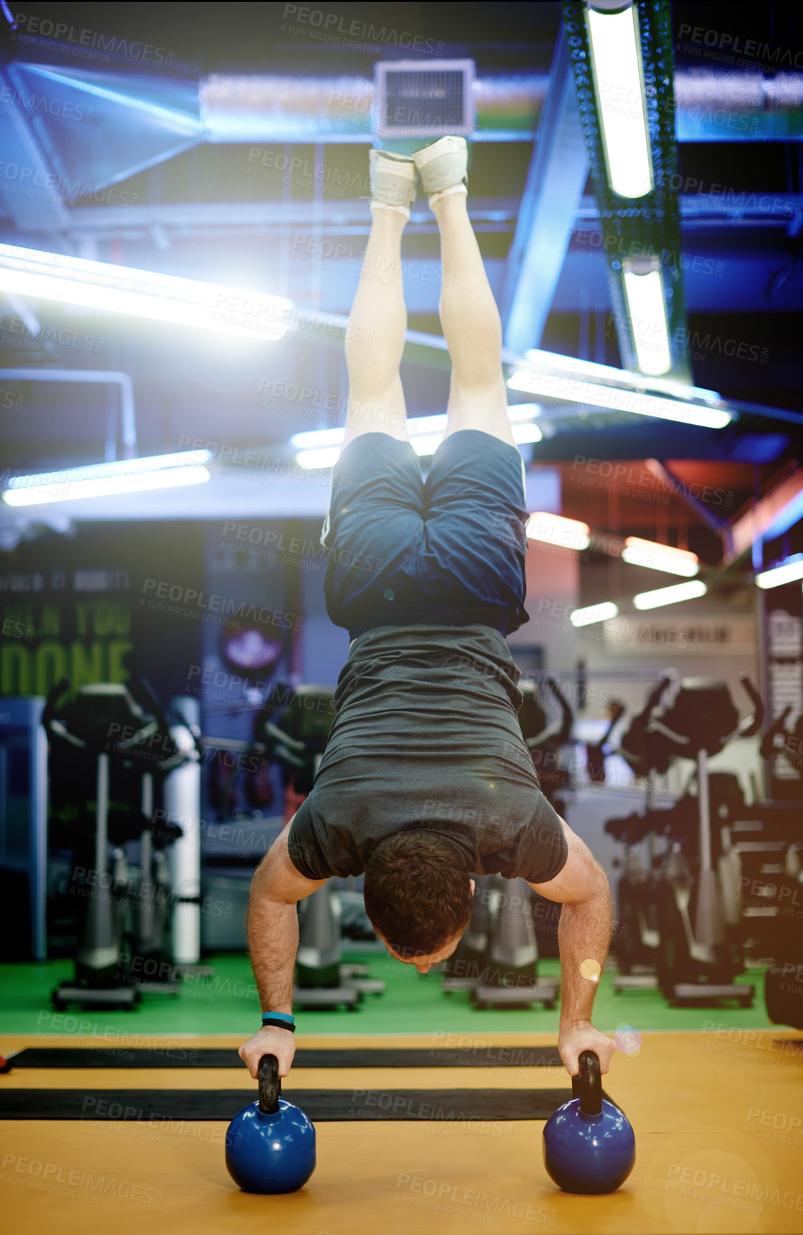 Buy stock photo Fitness, athlete and kettlebell handstand at gym for strength training, flexibility and muscular endurance. Balance, man and calisthenics with weights for functional exercise, night workout or health