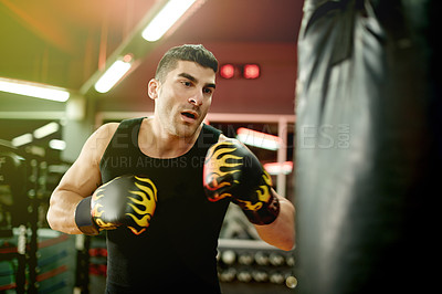 Buy stock photo Boxing bag, sports and man in gym for training, challenge or cardio activity for practice. Health, intense power and male athlete with punching equipment for performance or exercise in fitness center