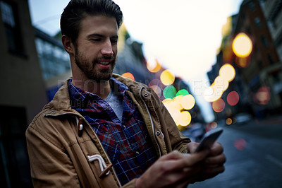 Buy stock photo Phone, street and man in city with social networking, communication or contact with mobile app. Waiting, happy and male person with cellphone for chatting with online dating in urban town with lights