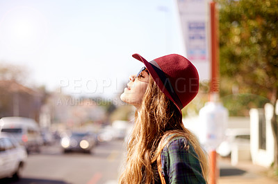Buy stock photo Girl, relax and waiting at bus stop in city for travel ideas, public transport and sightseeing abroad. Female teenager, sunbathing and tourist explore, morning commute and reflection for getaway trip