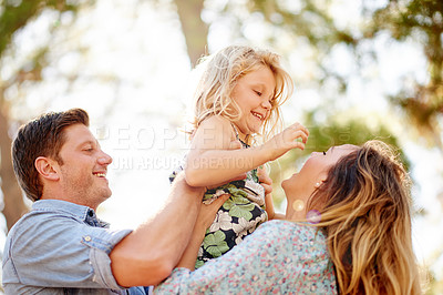 Buy stock photo Happy, outdoor and parents with child for bonding, care and family time on holiday together. Smile, love and girl kid with mother and father for playing and hugging in nature by trees for adventure.