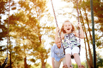 Buy stock photo Swinging, father and girl in park, excited and bonding together with happiness, game and smile. Outdoor, family and dad with daughter, weekend break and parent in playground, portrait and holiday