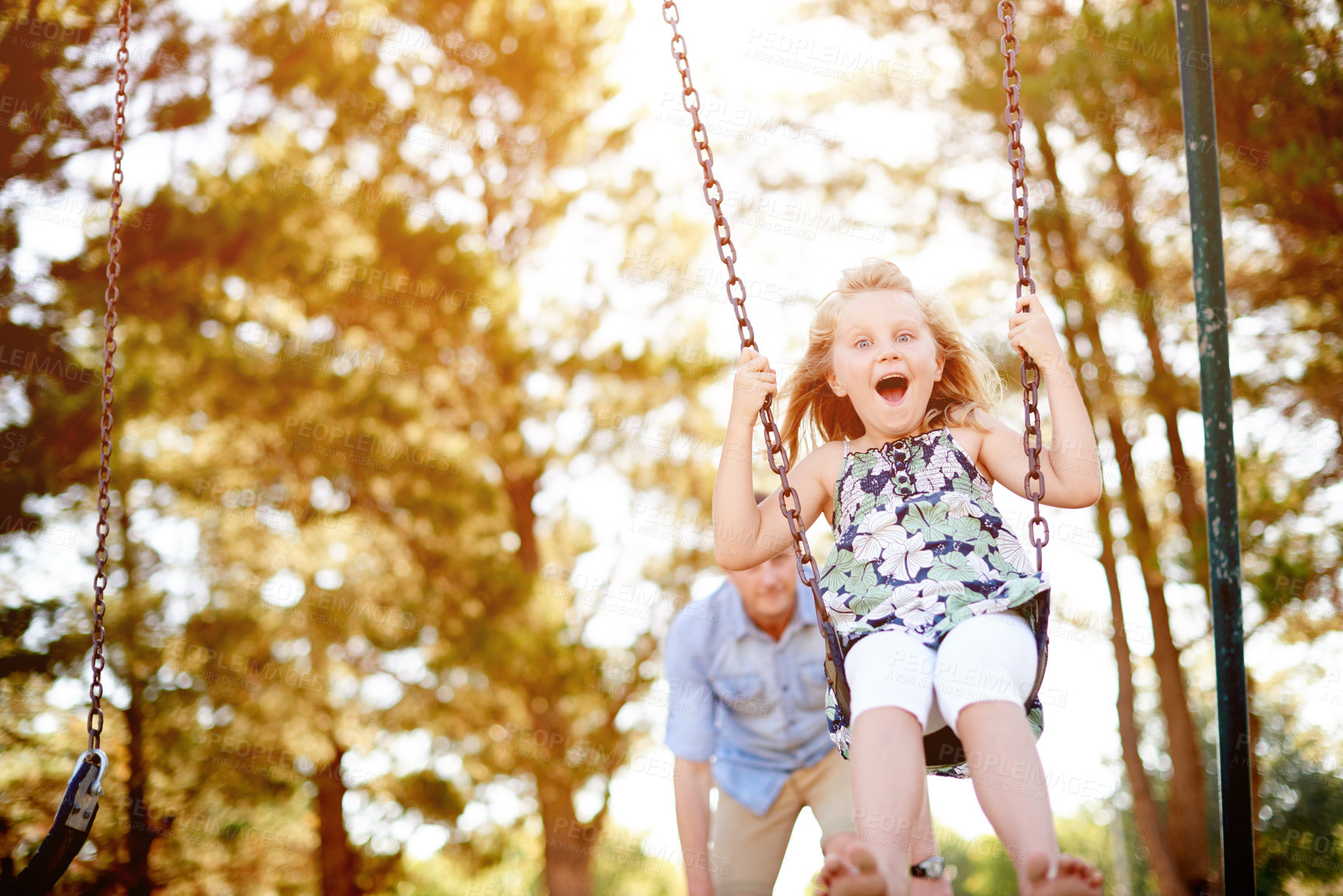 Buy stock photo Swinging, father and girl in park, excited and bonding together with happiness, game and smile. Outdoor, family and dad with daughter, weekend break and parent in playground, portrait and holiday