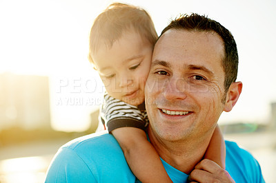 Buy stock photo Dad, baby and piggyback at beach with portrait, connection or love for father son bonding on holiday. Happy man, boy child with hug outdoor, sunshine and adventure with travel smile in Australia